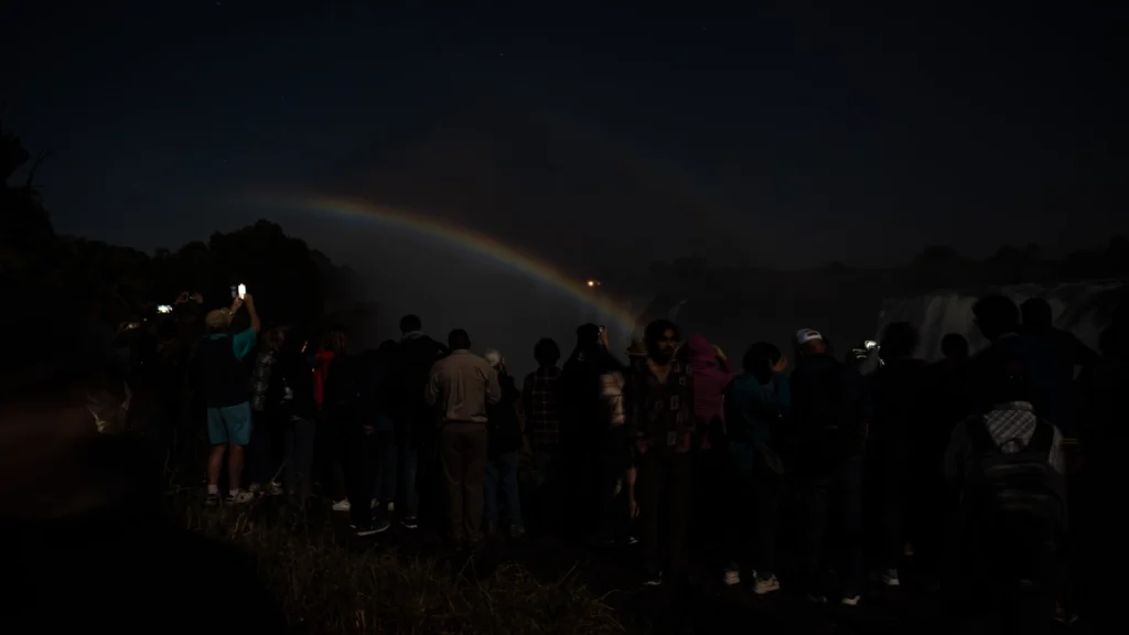 Wild Horizons tour group walking through Victoria Falls Rainforest on a lunar rainbow night tour