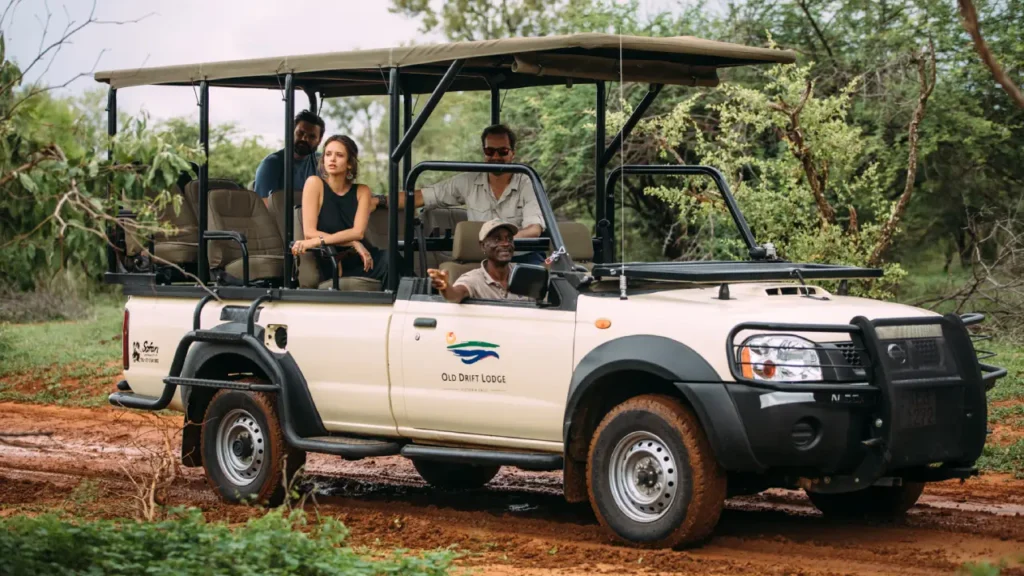 Family on open 4x4 game drive in Zambezi National Park near Victoria Falls, Zimbabwe