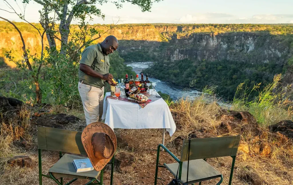 Cocktails and canapés sundowner on the Batoka Gorge rim, exclusive to The Elephant Camp guests