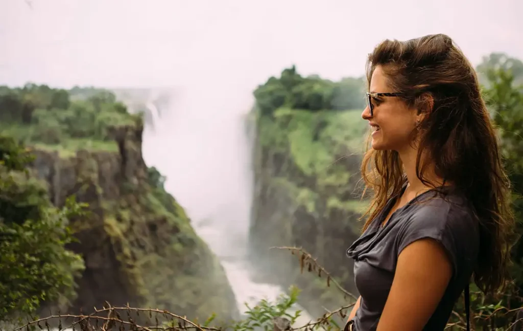 Tourists walking along Victoria Falls with spray Zimbabwe