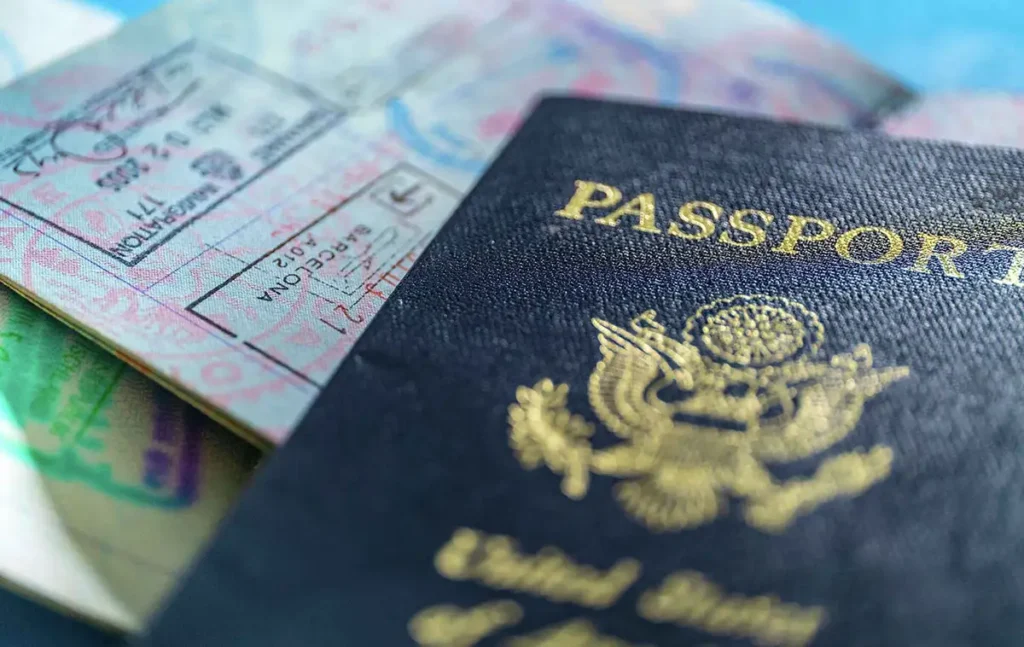 A passport, KAZA Univisa stamp and a smartphone showing the Zimbabwe online immigration form