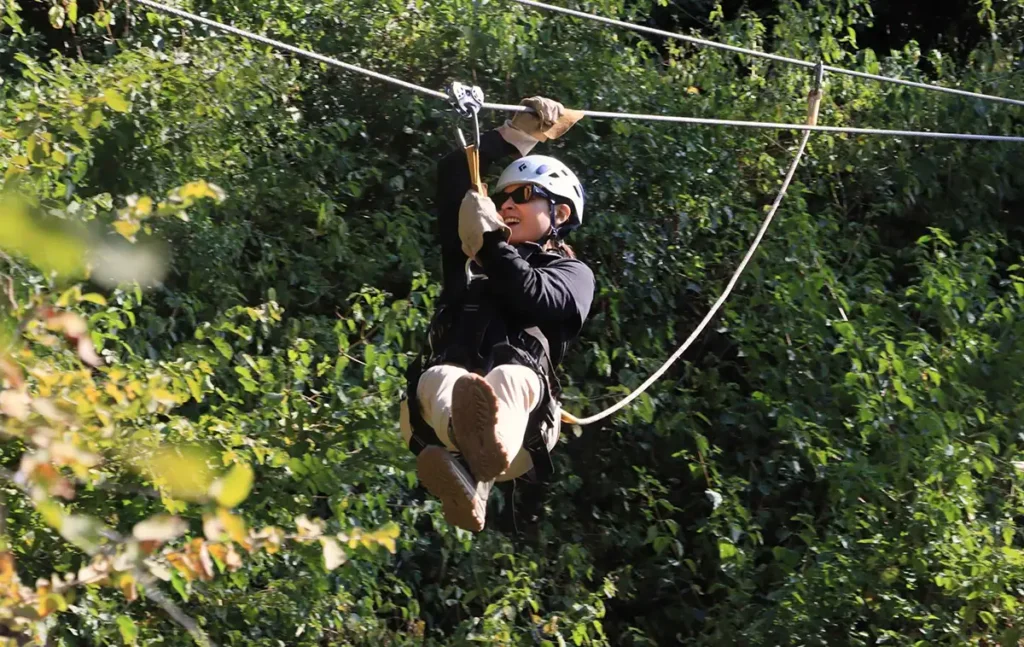 Woman completing a canopy tour zip-line in Victoria Falls Zimbabwe