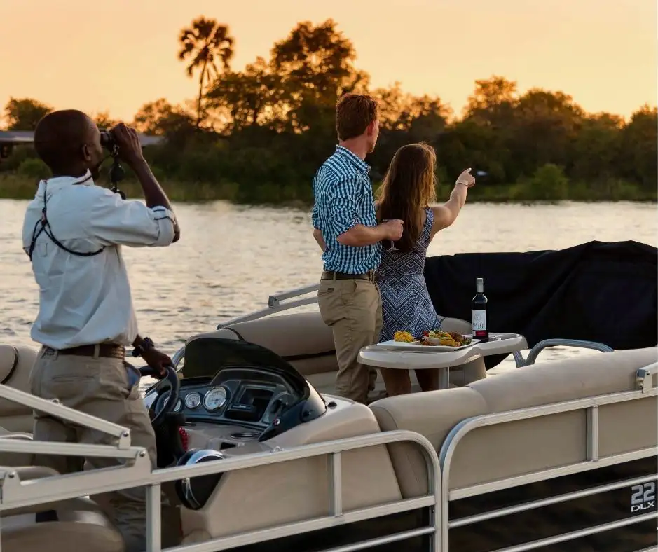 Guests on a sunset river safari on the Zambezi from Old Drift Lodge