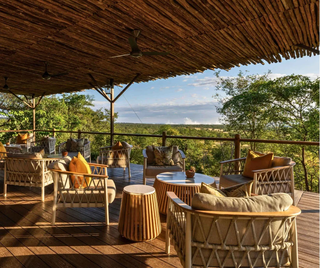 The Elephant Camp main deck at dusk, looking across the Batoka Gorge toward the spray of Victoria Falls.