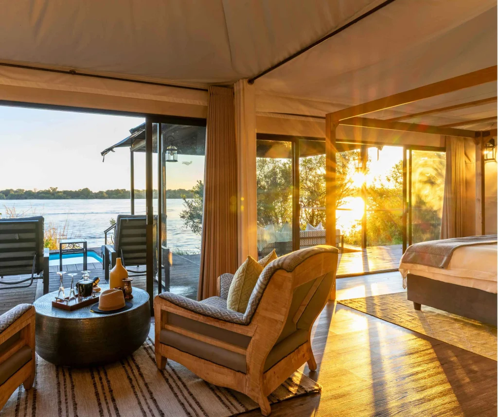 A luxury tented suite deck at Old Drift Lodge overlooking the Zambezi River inside Zambezi National Park.